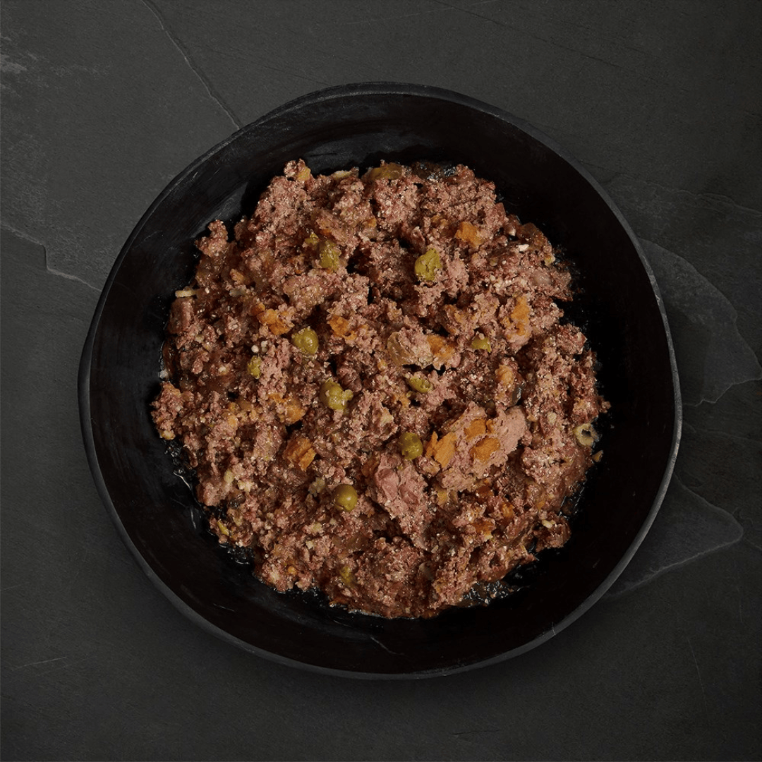 Canagan Puppy Feast Wet Food 400g served in a bowl. Chunky mince like texture with vegetables.