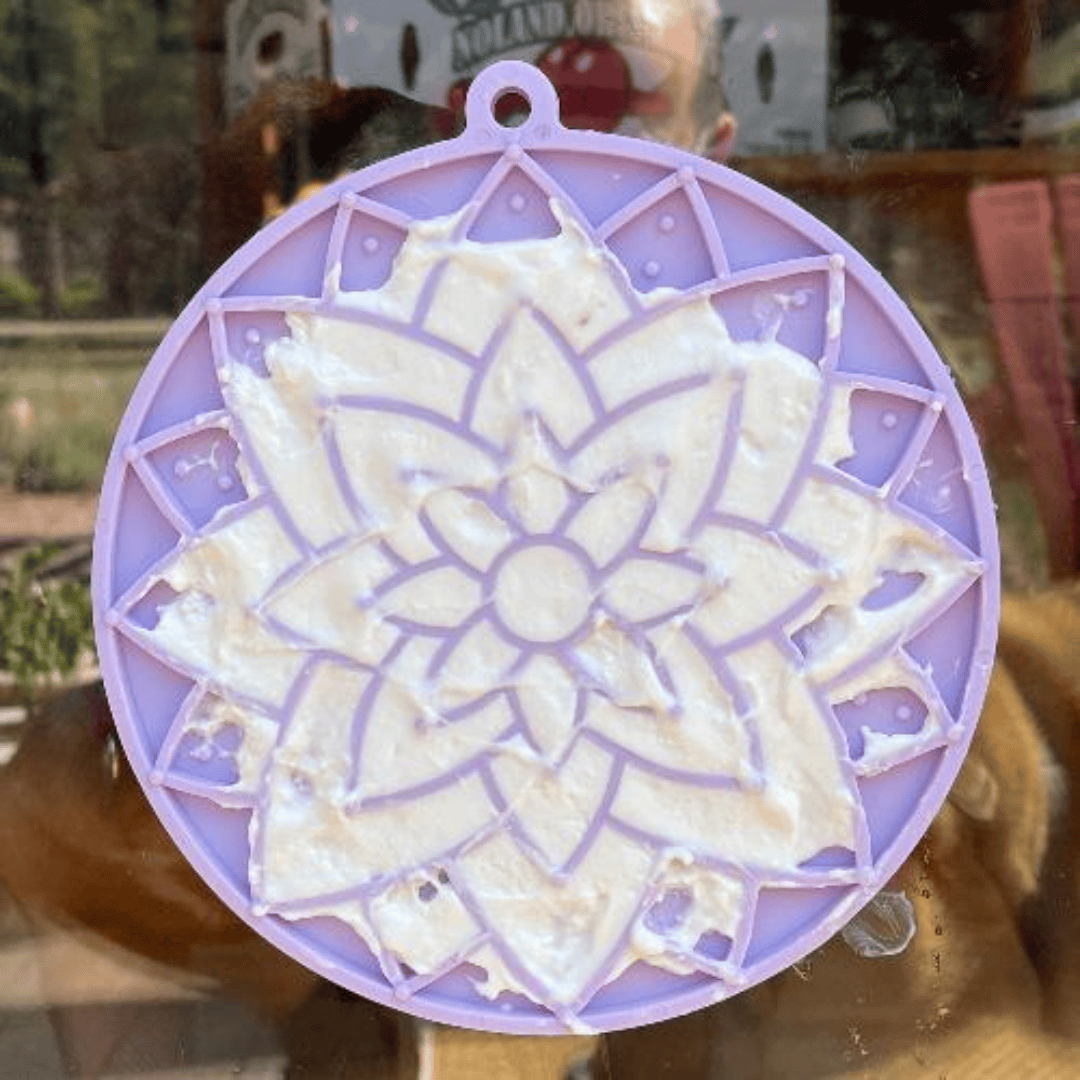 Some yoghurt spread onto the SodaPup Lotus eMat. This is stuck o a glass door pane.