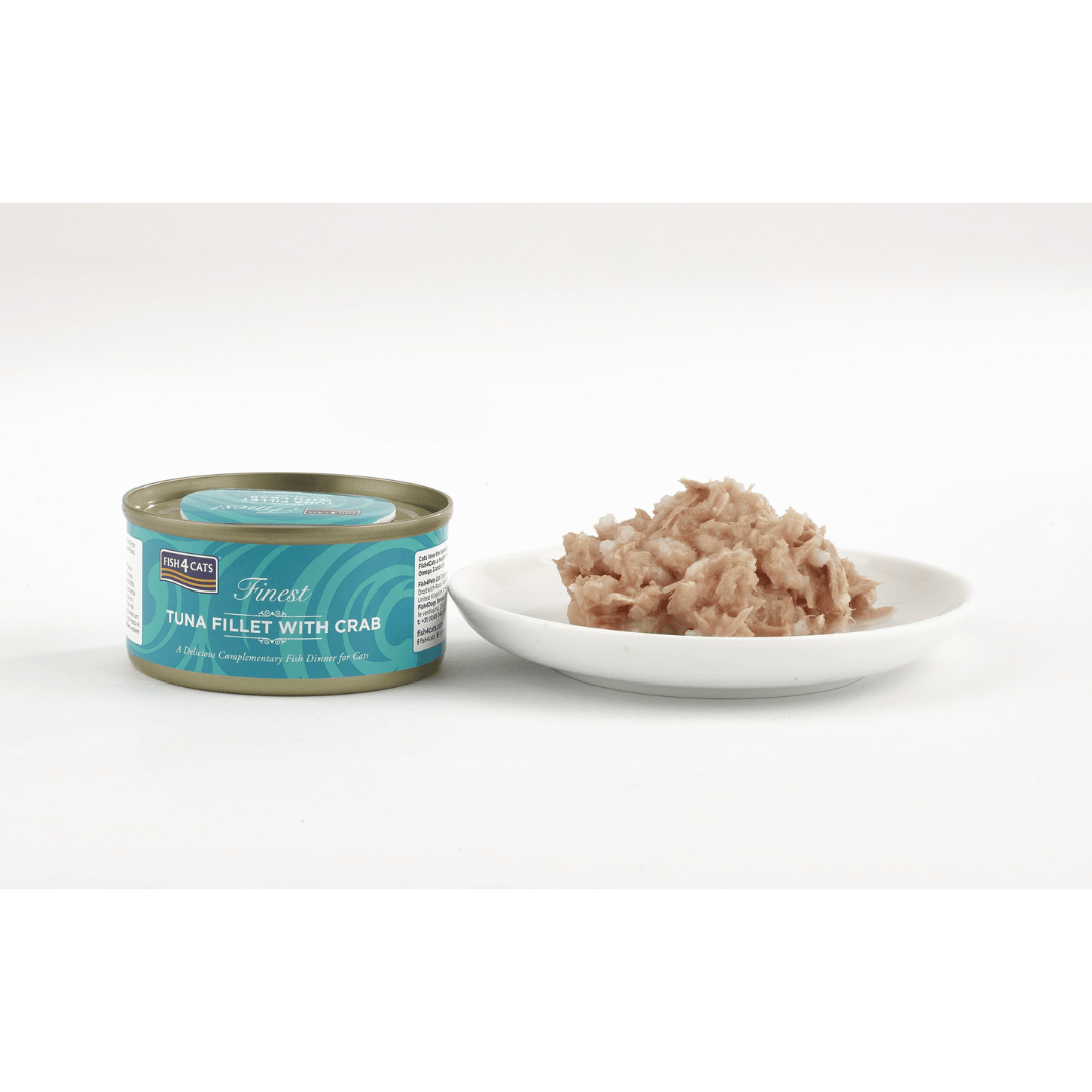 Cat food can labeled 'Finest Tuna Fillet with Crab' next to a white bowl with cat food on a white background