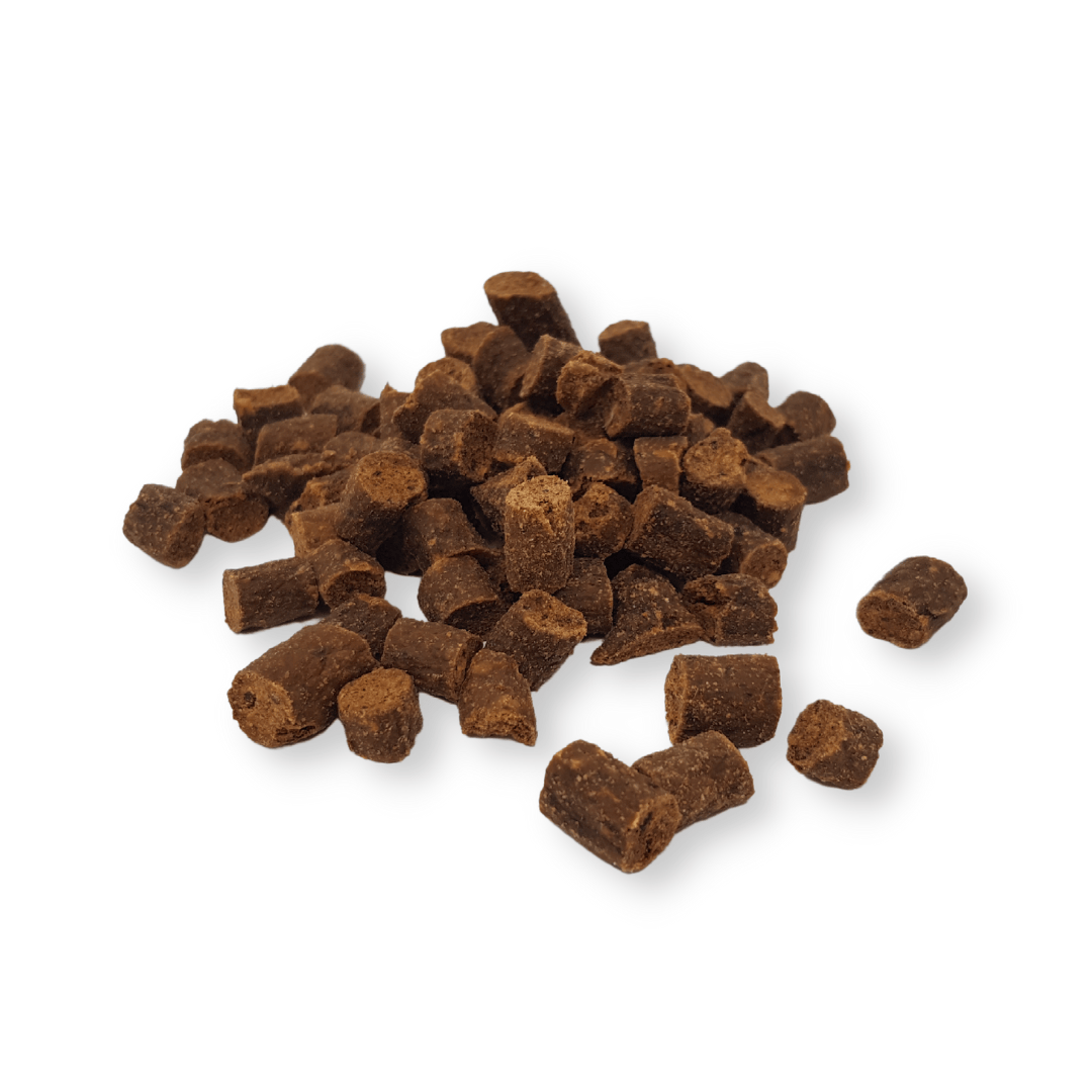 Pile of kangaroo chips dog treats on a white background