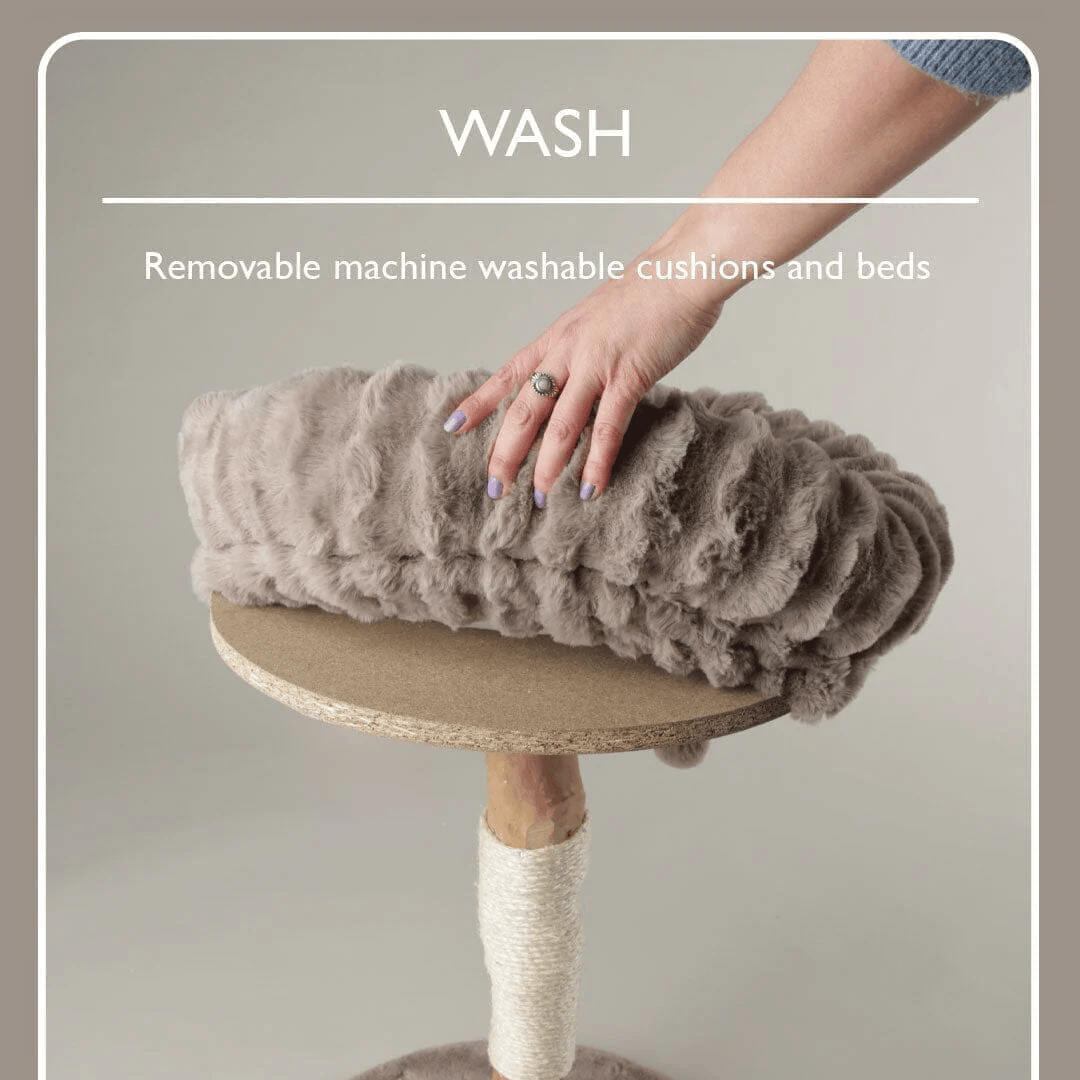 Cat tree with a cushion being held by a hand, text about machine washable cushions and beds.