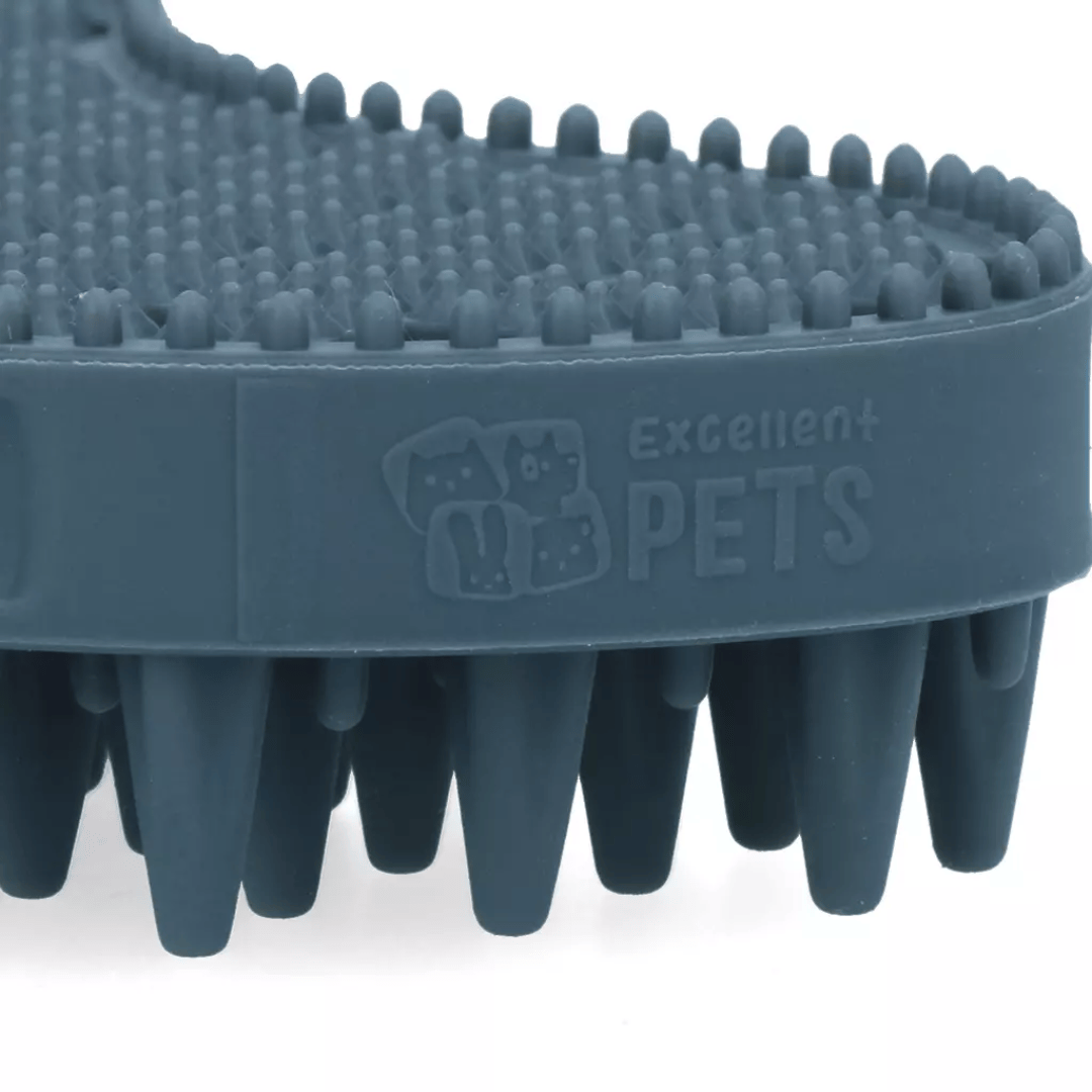 Close-up of a dark gray pet grooming brush with nubs and silicone bristles, featuring the embossed brand name 'Excellent Pets' on the side, set against a plain white background.