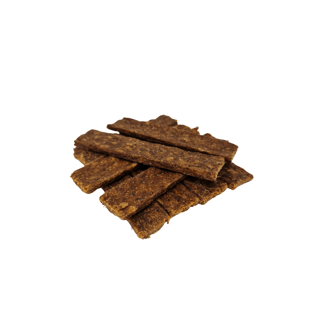 Stack of rabbit strips dog treats on a white background
