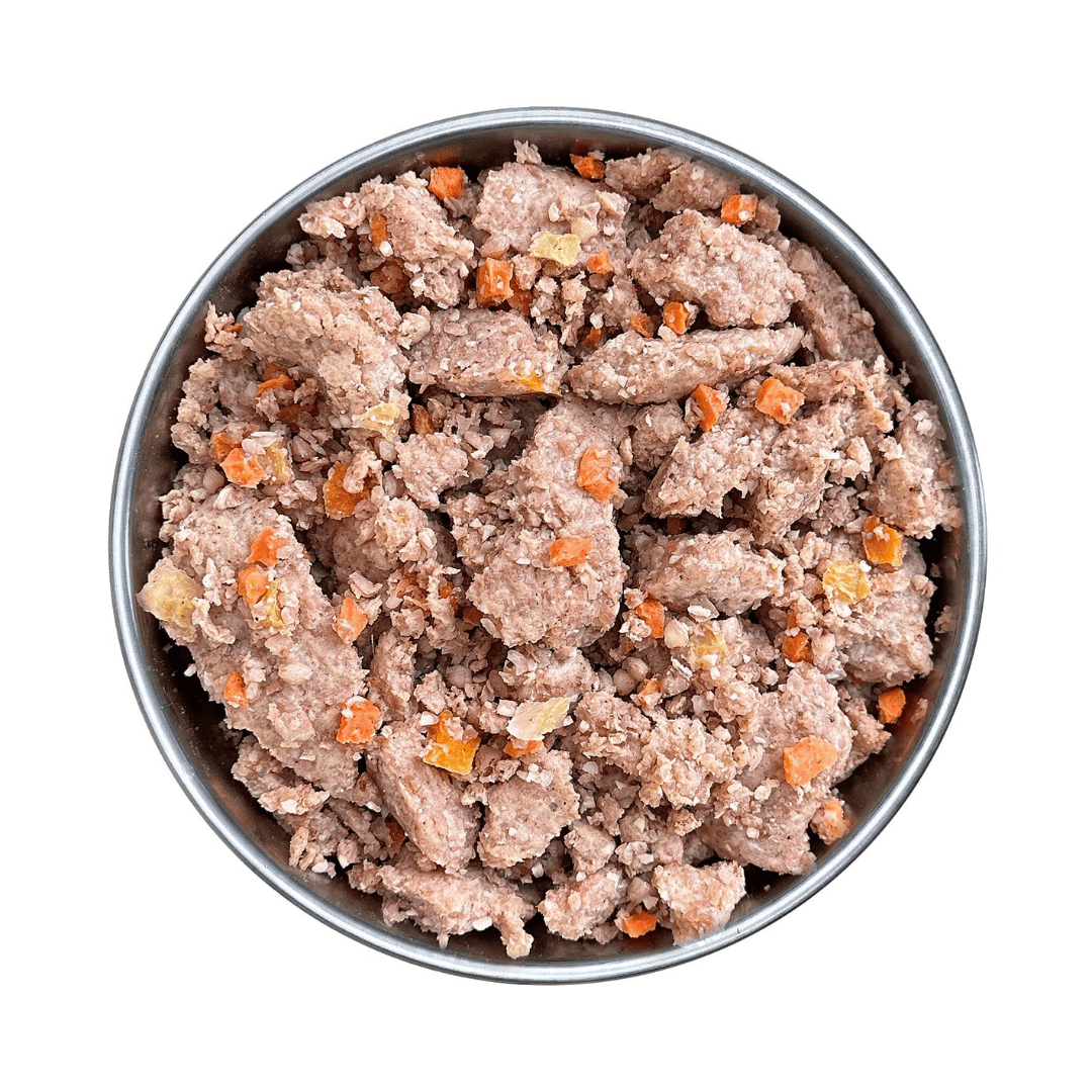 Fidelis pork menu in a metal bowl. Pieces of pork meat and vegetables.
