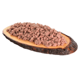 The Carnilove Duck with Timothy grass wet dog food served on a wooden dish has a chunky consistency with many different textures throughout.