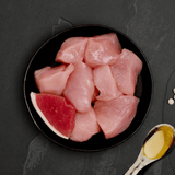 The Fresh ingredients of the Canagan Chicken with Ham Cat Food Tin 75g displayed on a plate.