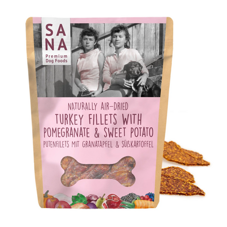 Bag of Sana Air Dried Turkey, Sweet Potato and Pomegranate Fillets for dogs, in front of four of the same treats.