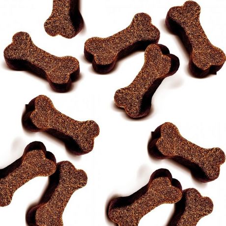 The Carnilove Duck with Rosemary soft snacks are a bone shape. They are spread out on a white background.