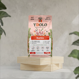 Bag of Ydolo dog food on a wooden platform.