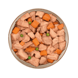 Pet food bowl with pork, carrots, and peas on a white background
