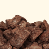 Close-up of brown duck pieces on a beige background
