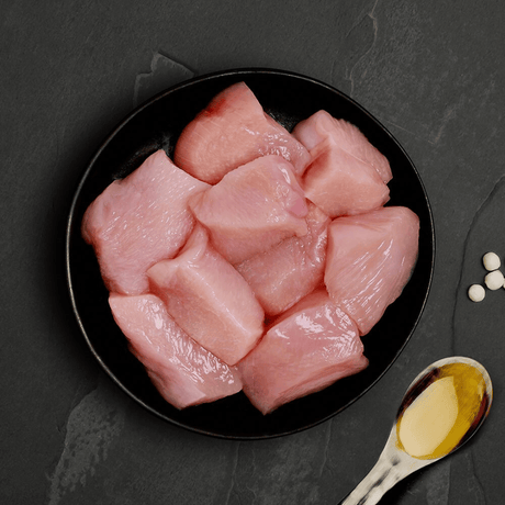 The fresh ingredients of the Canagan Fresh Chicken Cat Food Tin 75g displayed on a plate
