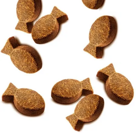 The Carnilove Quail with Oregano soft snacks are a fish shape. They are spread out on a white background.