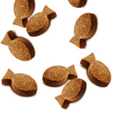 The Carnilove Sardine with wild garlic soft snacks are a fish shape. They are spread out on a white background.