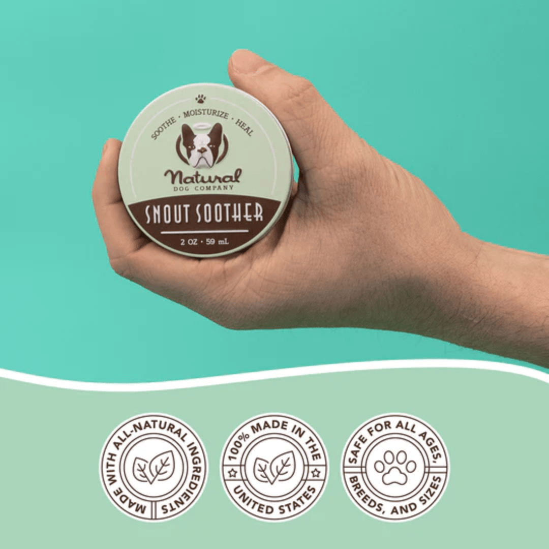 Phot of a hand holdint the Snout Soother tin.