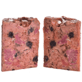 The Carnilove Lamb and Wild Boar wet dog food removed from the tin and cut in half to show it's profile. You can see many different textures and ingredients including fruit